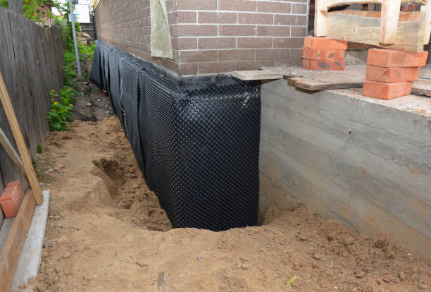 Happy homeowners after waterproofing job in Darby